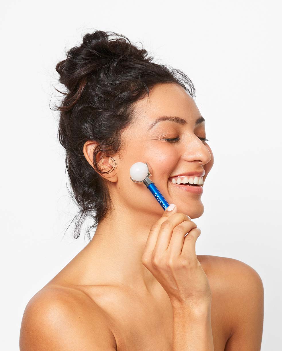Rollmate Facial Roller being used by model