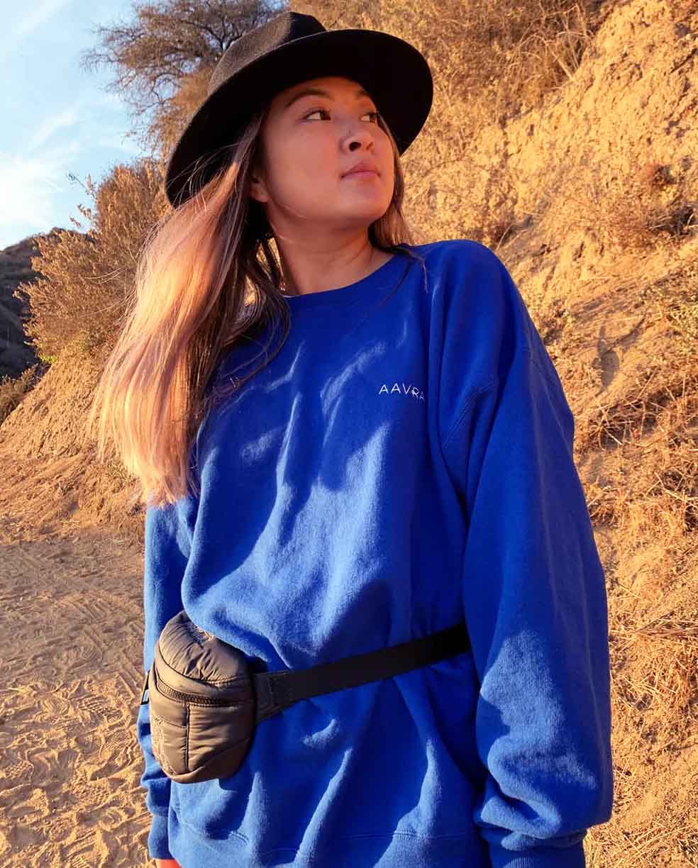 AAVRANI Hyper Blue Crewneck being worn on a hike by AAVRANI customer